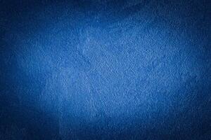 Blue decorative plaster texture with vignette. Abstract grunge background with copy space. photo
