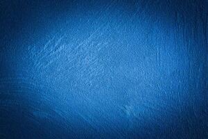 Blue decorative plaster texture with vignette. Abstract grunge background with copy space. photo