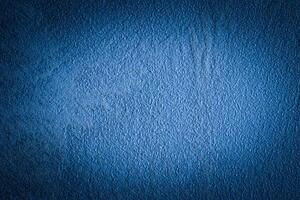 Blue decorative plaster texture with vignette. Abstract grunge background with copy space. photo