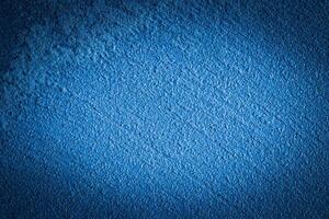 Blue decorative plaster texture with vignette. Abstract grunge background with copy space. photo