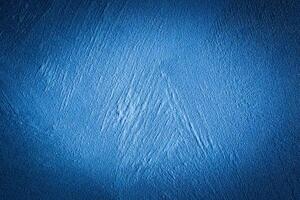 Blue decorative plaster texture with vignette. Abstract grunge background with copy space. photo