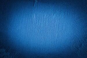 Blue decorative plaster texture with vignette. Abstract grunge background with copy space. photo