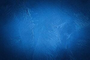 Blue decorative plaster texture with vignette. Abstract grunge background with copy space. photo
