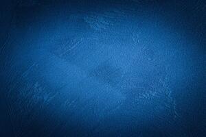 Blue decorative plaster texture with vignette. Abstract grunge background with copy space. photo