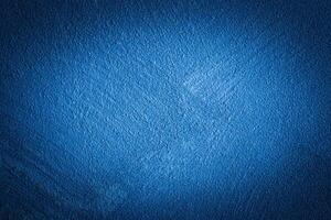 Blue decorative plaster texture with vignette. Abstract grunge background with copy space. photo