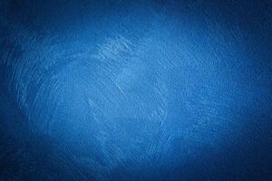 Blue decorative plaster texture with vignette. Abstract grunge background with copy space. photo