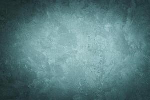 Cyan decorative plaster texture with vignette. Abstract grunge background with copy space. photo