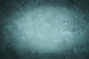 Cyan decorative plaster texture with vignette. Abstract grunge background with copy space. photo