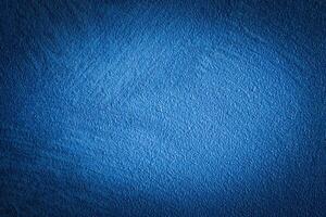 Blue decorative plaster texture with vignette. Abstract grunge background with copy space. photo