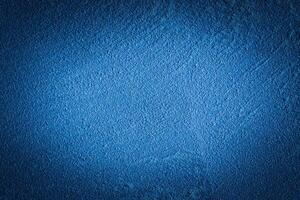 Blue decorative plaster texture with vignette. Abstract grunge background with copy space. photo