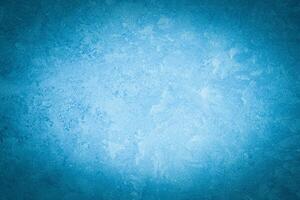 Cyan decorative plaster texture with vignette. Abstract grunge background with copy space. photo