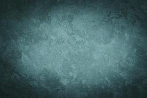 Cyan decorative plaster texture with vignette. Abstract grunge background with copy space. photo