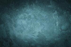 Cyan decorative plaster texture with vignette. Abstract grunge background with copy space. photo