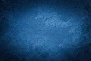 Blue decorative plaster texture with vignette. Abstract grunge background with copy space. photo