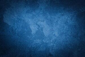 Blue decorative plaster texture with vignette. Abstract grunge background with copy space. photo