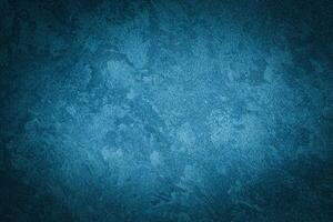 Cyan decorative plaster texture with vignette. Abstract grunge background with copy space. photo