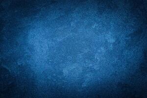Blue decorative plaster texture with vignette. Abstract grunge background with copy space. photo