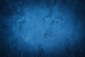 Blue decorative plaster texture with vignette. Abstract grunge background with copy space. photo