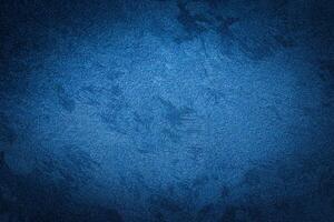 Blue decorative plaster texture with vignette. Abstract grunge background with copy space. photo