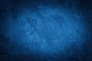 Blue decorative plaster texture with vignette. Abstract grunge background with copy space. photo