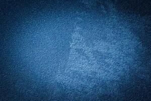 Blue decorative plaster texture with vignette. Abstract grunge background with copy space. photo