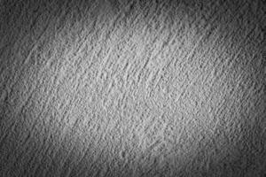 Gray decorative plaster texture with vignette. Abstract grunge background with copy space. photo