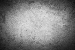 Gray decorative plaster texture with vignette. Abstract grunge background with copy space. photo