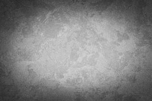 Gray decorative plaster texture with vignette. Abstract grunge background with copy space. photo