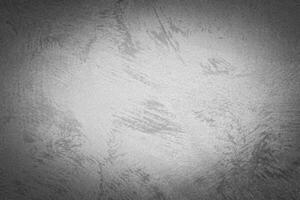 Gray decorative plaster texture with vignette. Abstract grunge background with copy space. photo