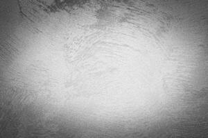 Gray decorative plaster texture with vignette. Abstract grunge background with copy space. photo