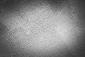 Gray decorative plaster texture with vignette. Abstract grunge background with copy space. photo