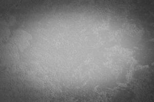 Gray decorative plaster texture with vignette. Abstract grunge background with copy space. photo