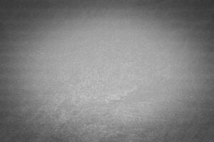 Gray decorative plaster texture with vignette. Abstract grunge background with copy space. photo
