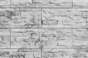 Black and white texture of a wall covered with decorative brick-like tiles. Abstract background for design. photo