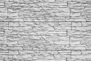 Black and white texture of a wall covered with decorative brick-like tiles. Abstract background for design. photo