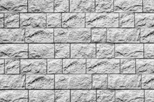 Black and white texture of a wall covered with decorative brick-like tiles. Abstract background for design. photo