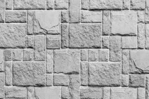 Black and white texture of a wall covered with decorative brick-like tiles. Abstract background for design. photo