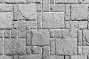 Black and white texture of a wall covered with decorative brick-like tiles. Abstract background for design. photo