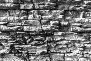 Black and white texture of a wall covered with decorative brick-like tiles. Abstract background for design. photo