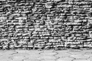Black and white texture of a wall covered with decorative brick-like tiles. Abstract background for design. photo