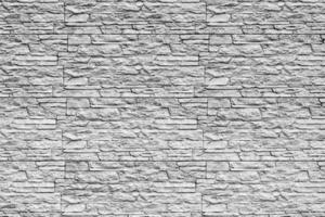 Black and white texture of a wall covered with decorative brick-like tiles. Abstract background for design. photo
