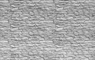 Black and white texture of a wall covered with decorative brick-like tiles. Abstract background for design. photo