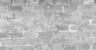 Monochrome texture of a wall made of concrete blocks connected cement. Abstract black and white background. photo