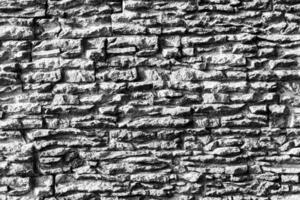 Black and white texture of a wall covered with decorative brick-like tiles. Abstract background for design. photo