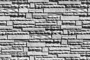 Black and white texture of a wall covered with decorative brick-like tiles. Abstract background for design. photo