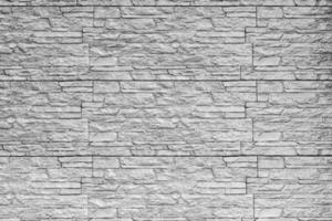 Black and white texture of a wall covered with decorative brick-like tiles. Abstract background for design. photo