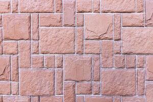 Texture of a wall covered with decorative brick-like tiles. Abstract background for design. photo