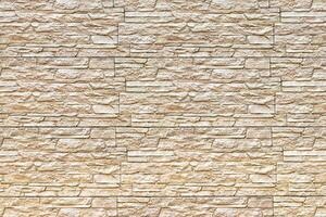 Texture of a wall covered with decorative brick-like tiles. Abstract background for design. photo