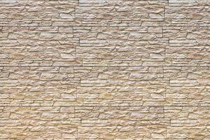 Texture of a wall covered with decorative brick-like tiles. Abstract background for design. photo