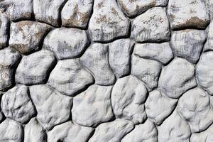 Black and white texture of a wall made of stones. Abstract background. photo